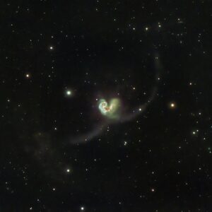 Mesmerizing image of a distant galaxy surrounded by stars in the vastness of outer space.