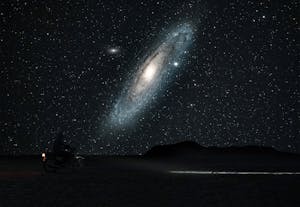 A lone motorcyclist travels under the stunning Andromeda Galaxy in Semnan, Iran.
